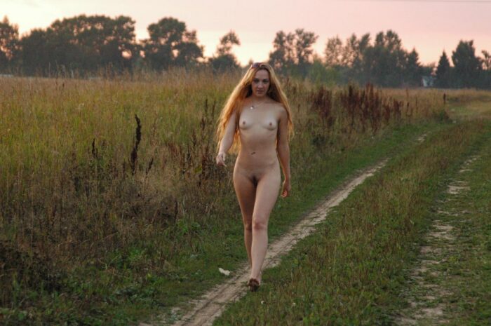 Young blond Asja with long hair and small tits in the field