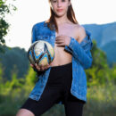 Annamalia takes off her denim jacket and biker shorts and flashes her bubble butt and hairless cunt in the middle of the field.
