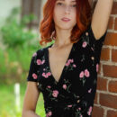 Beautiful red haired Elin Flame enticingly undress by the brick pillar and uncover her flawless slim physique and trimmed cunt.