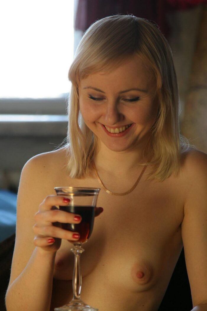 Blonde Natasha K with a glass of wine spreads legs