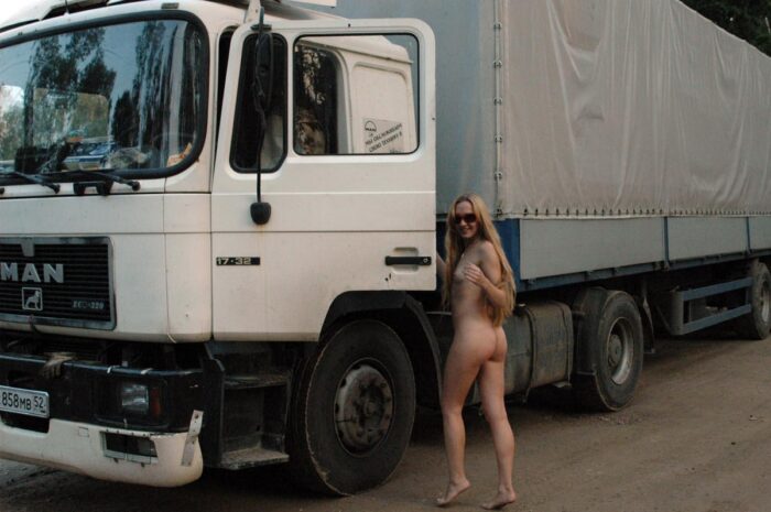 Shameless blonde Asja is photographed by a truck