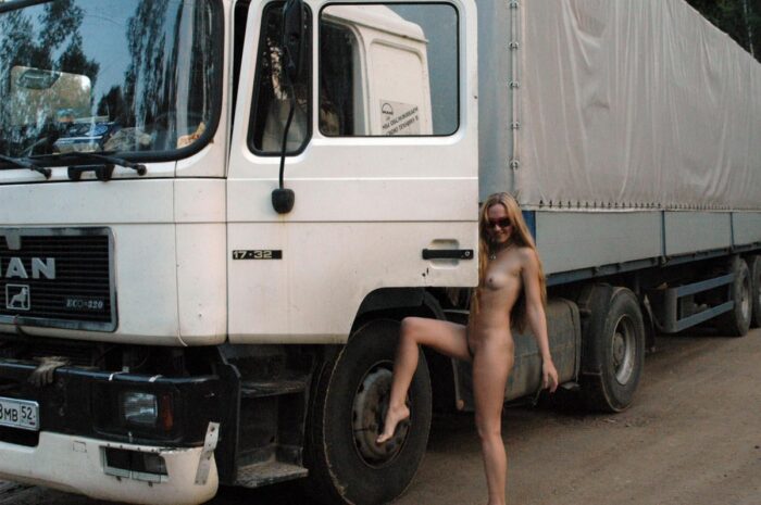 Shameless blonde Asja is photographed by a truck