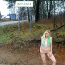 Young girl Kristina P with bright dreadlocks on a dirt road