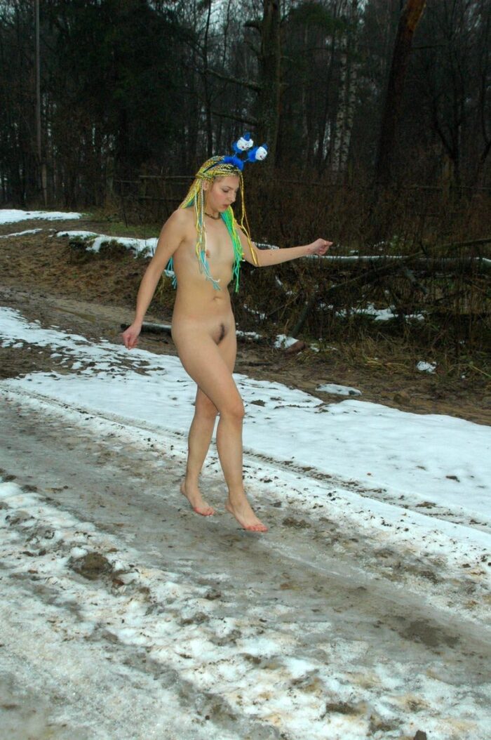 Young girl Kristina P with bright dreadlocks on a dirt road