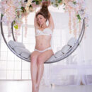 Emerald Ocean relaxes on an indoor swing covered in beautiful flowers as she flaunts her juicy melons and bumtastic figure.