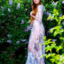 Hailey looks like a goddess in her lace see through dress as she stroll along the lilac bushes. She undresses and exposes her flawless skin and hairless cunt.
