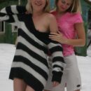 Two bare blondes undress and play in the snow