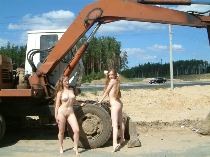 Two blonde sisters completely without clothes on the construction site