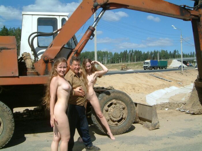 Two blonde sisters completely without clothes on the construction site