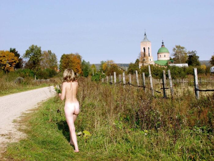 A girl Natalia K without clothes meets a stranger in a Russian village