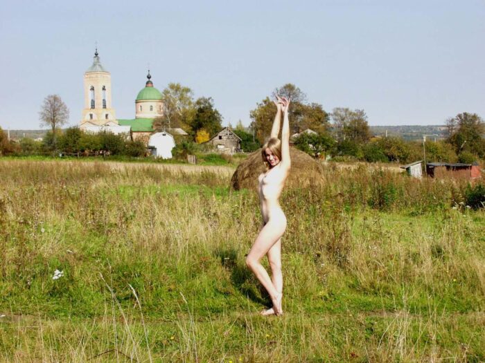 A girl Natalia K without clothes meets a stranger in a Russian village