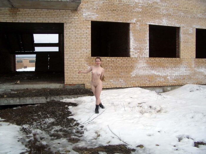 Blonde Alena B without clothes posing with a stranger on an abandoned building