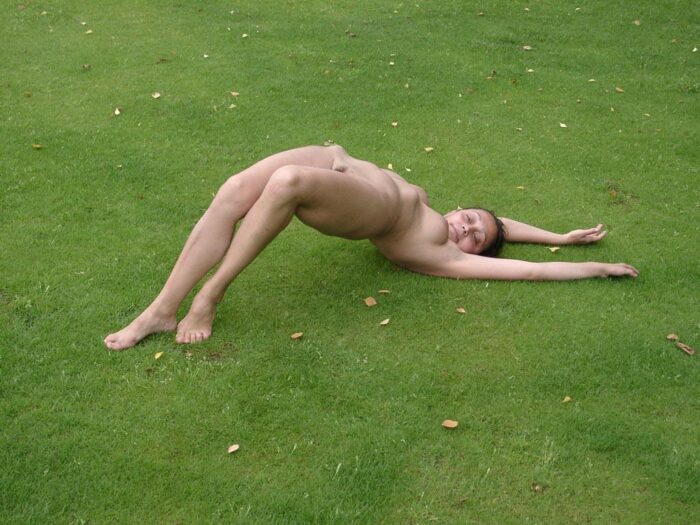 Girl Luisa makes sports exercises naked on the lawn