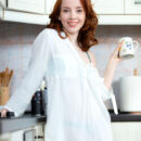 Lottie Magne drinks a cup of tea in the kitchen and decides to unbutton her white shirt and strips off her blue sexy lingerie, lifts her sexy legs on the kitchen countertop and starts to fondle her pinkish manicured pussy.