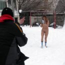 Naked Lena W plays snowball with dressed strangers