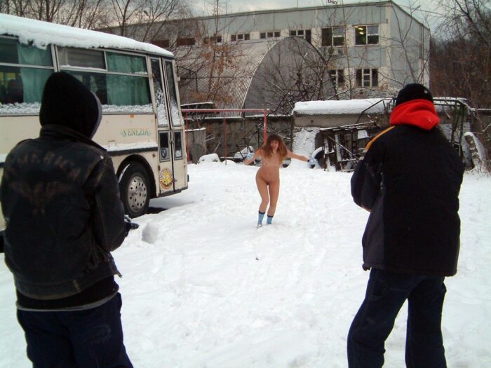 Naked Lena W plays snowball with dressed strangers