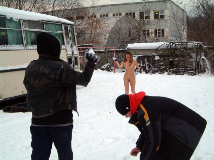 Naked Lena W plays snowball with dressed strangers