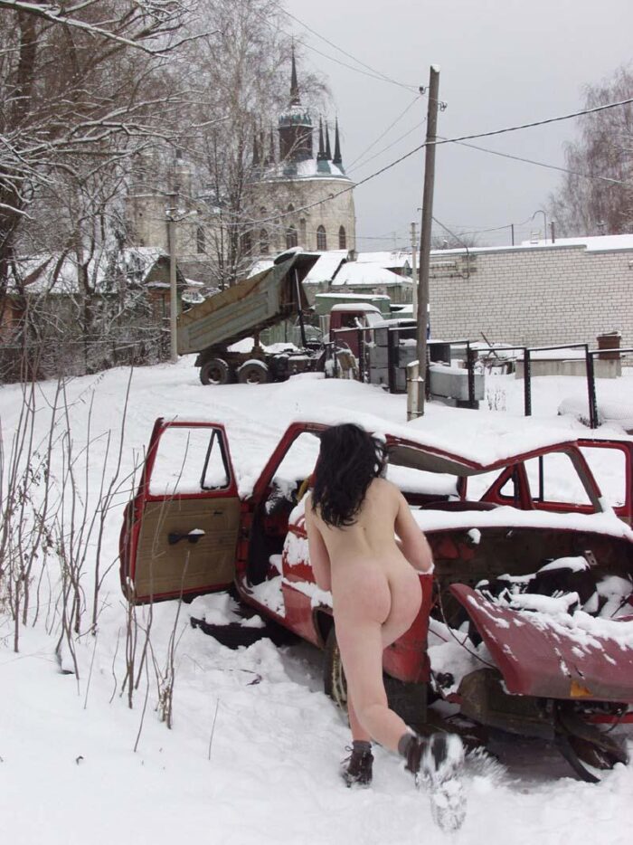 Naked young girl Masha R with a beautiful ass posing in a broken car