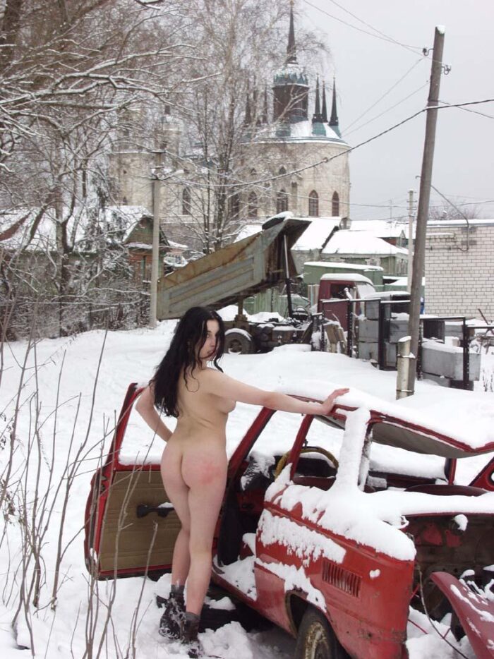 Naked young girl Masha R with a beautiful ass posing in a broken car