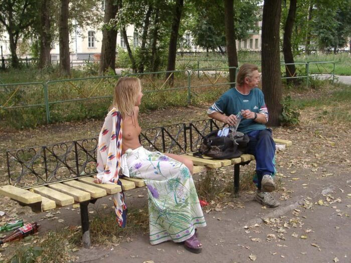 Russian blonde Elena posing on a bench with drunkard