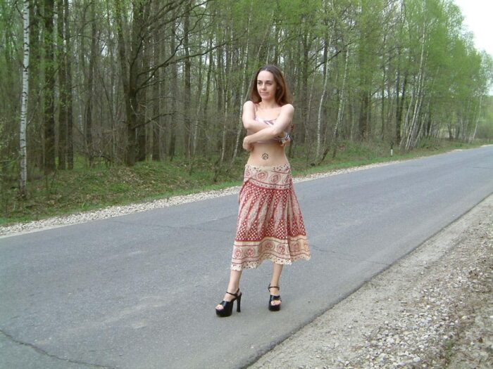 Russian girl Olla with a gorgeous body walks on the road