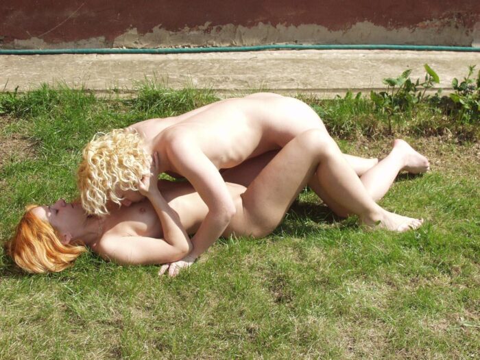 Two hot young lesbians lying on the grass in the country