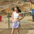 Young brunette Ruzanna undresses on the construction site