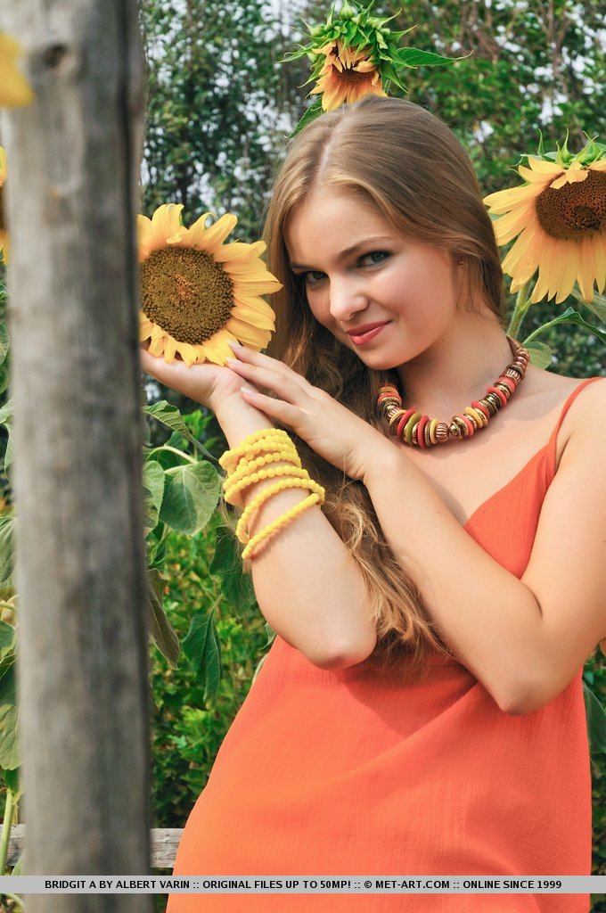 Bridgit A’s natural beauty and youthful body stands out amongst the lovely sunflowers