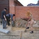 Girl Lilia in black boots on construction site