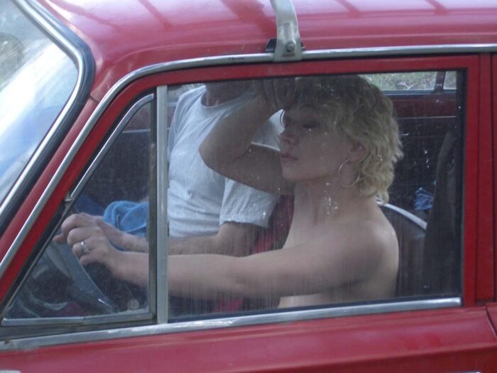 Naked short-haired blonde car and the broken car