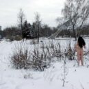 Young brunette Masha R walks naked in the snow in the city