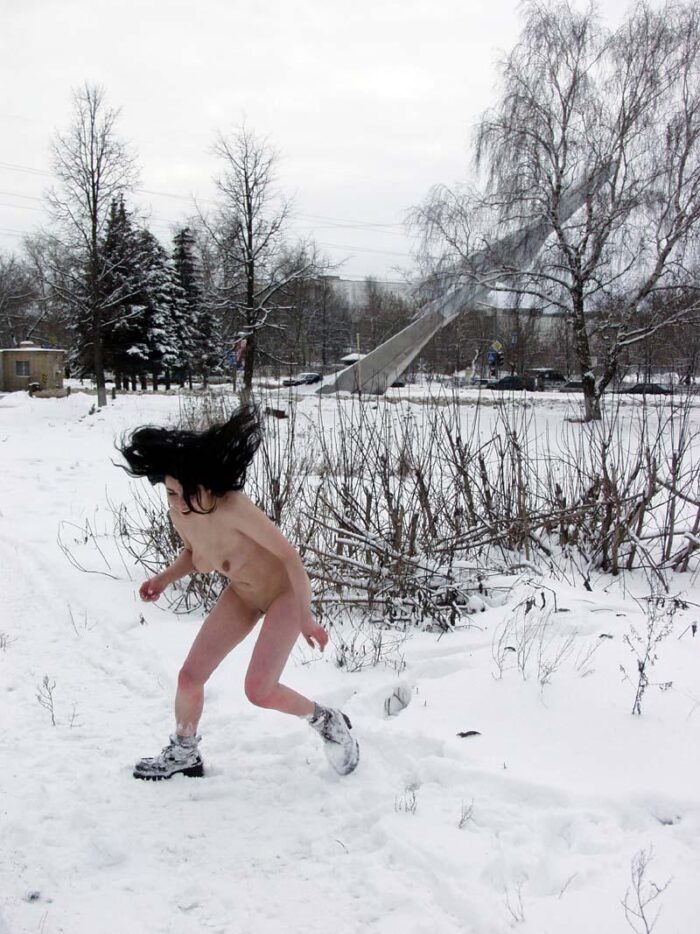Young brunette Masha R walks naked in the snow in the city