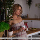 Amber Pearl drinks coffee in kitchen. She divest her clothes and exposes her slim physique and manicured cunt.