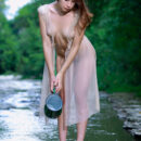 Annamalia grabs a pitcher of water by the river which she then purs over her sexy bod and gets her dainty dress wet.