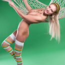 Fun and sweet Lapochka looks absolutely stunning in her bright striped stockings and yellow headband, posing playfully in a fishnet hammock.