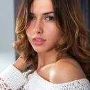 Nadine B bends over and shows off her assets