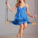 Tamara playfully poses on a swing, lifting her dress` skirt naughtily to flash her smootj, shaven pussy.
