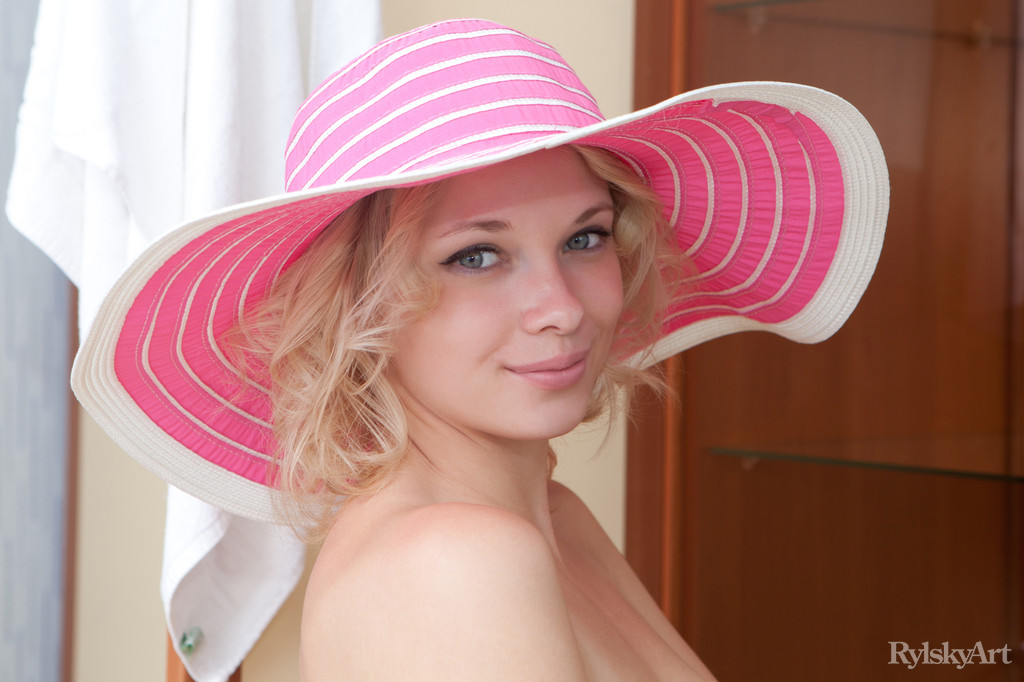 Master photographer Rylsky captures the elegant yet naughty allure of Feona as she poses confidently with her pink hat on.
