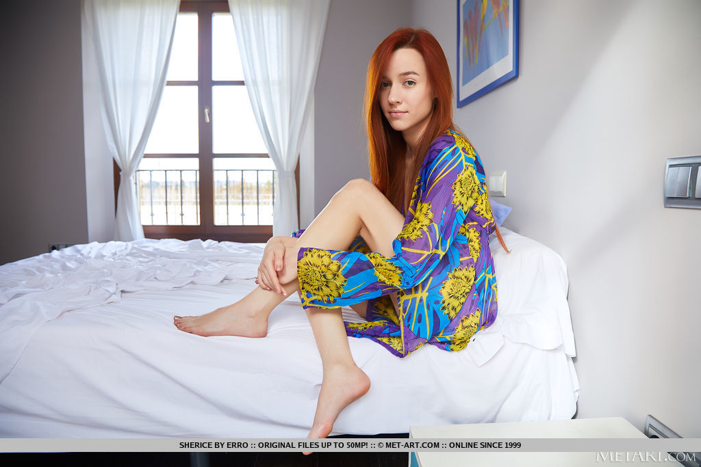 Gorgeous red haired Sherice disrobe on the bed and flings her sexy feet high in the air, giving an open view of her smooth cunt.