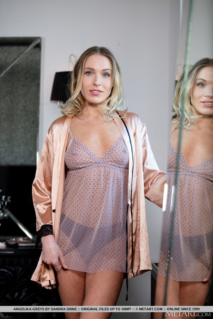 Angelika Greys enticingly strips off her see through dainty lingerie and flashes her slender fit figure and hairless pinkish coochie infront of the bathroom mirror.