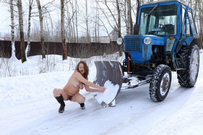 Blonde with hairy pussy posing by the tractor