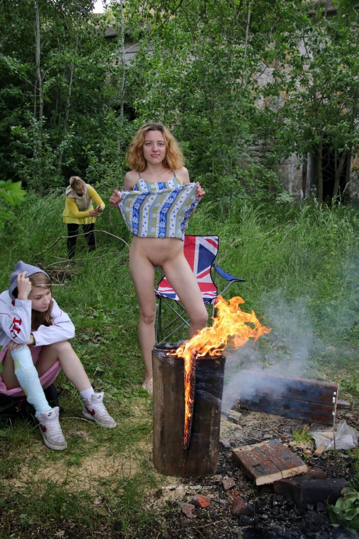 Blonde woman Alexandra K spreading her legs at the campfire