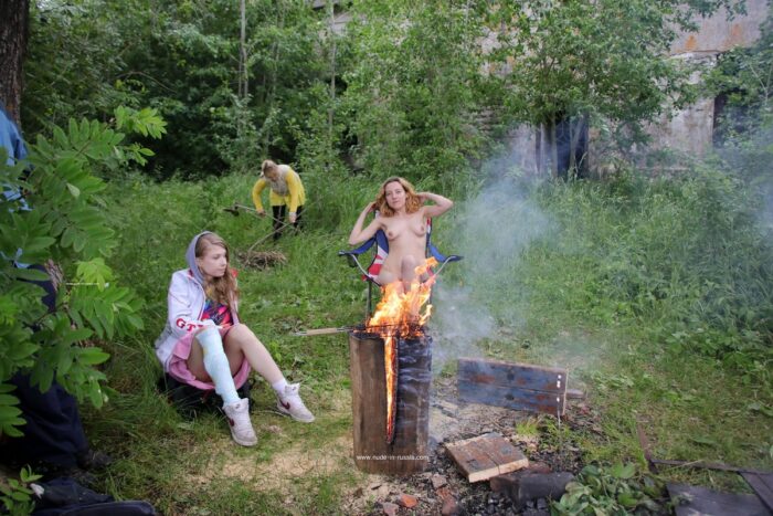 Blonde woman Alexandra K spreading her legs at the campfire