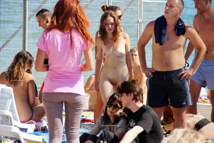 Lots of people look at two shameless young naked girls