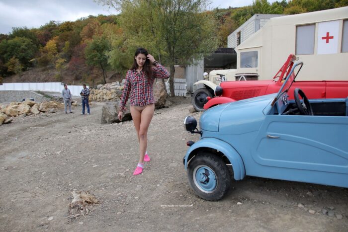 Girl Katja P in pink socks near old cars