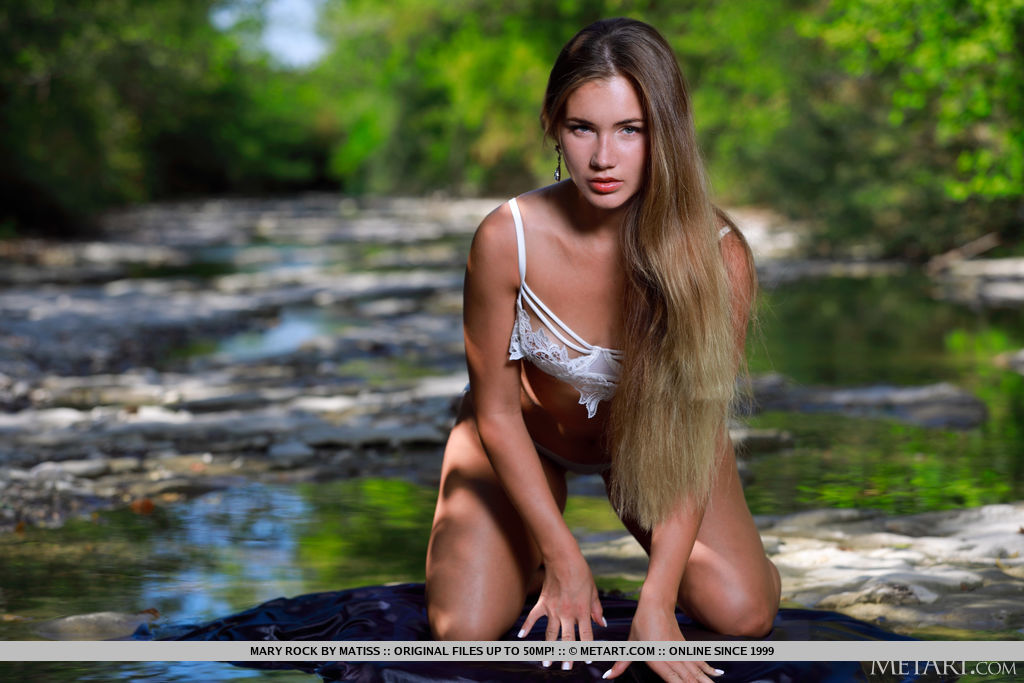 Lovely Mary Rock takes off her white lace lingerie and exposes her beautifully sun-kissed skin by the flowing river.