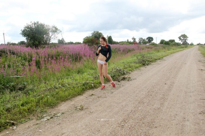 Pretty girl Abbey takes off her white panties on a country road