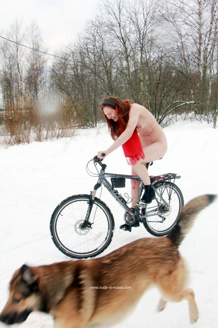 Russian young red-haired girl Alina S is trying to ride a bike