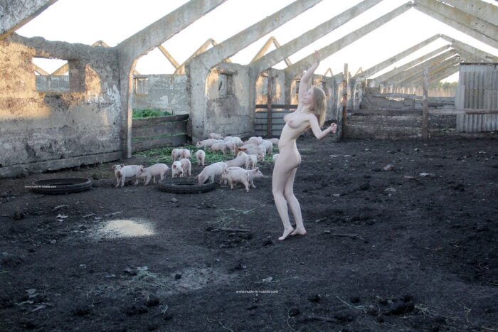 Young blonde Seshat undresses in a pigsty