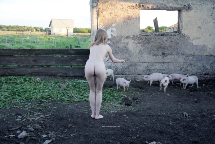 Young blonde Seshat undresses in a pigsty